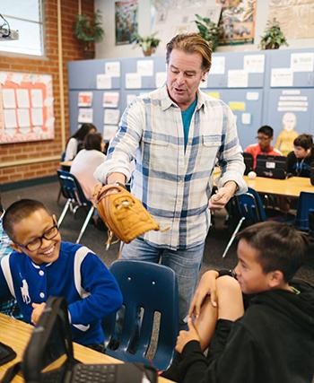 格雷·麦克福尔戴着棒球手套在教学生